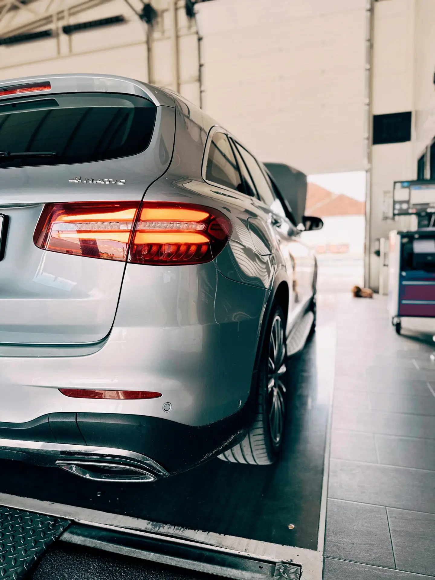 Home Rear view of a luxury car in a modern garage setting.